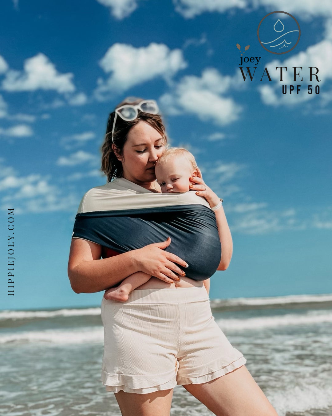Joey Water (Sling/ Wrap/ baby carrier type assistant garment)  being used on the beach to keep baby safe and secure while swimming in ocean.